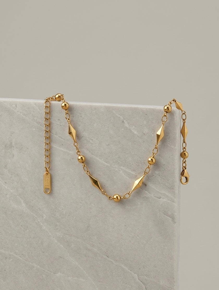 PULSERA CON ESLABONES DE ARROZ DORADA