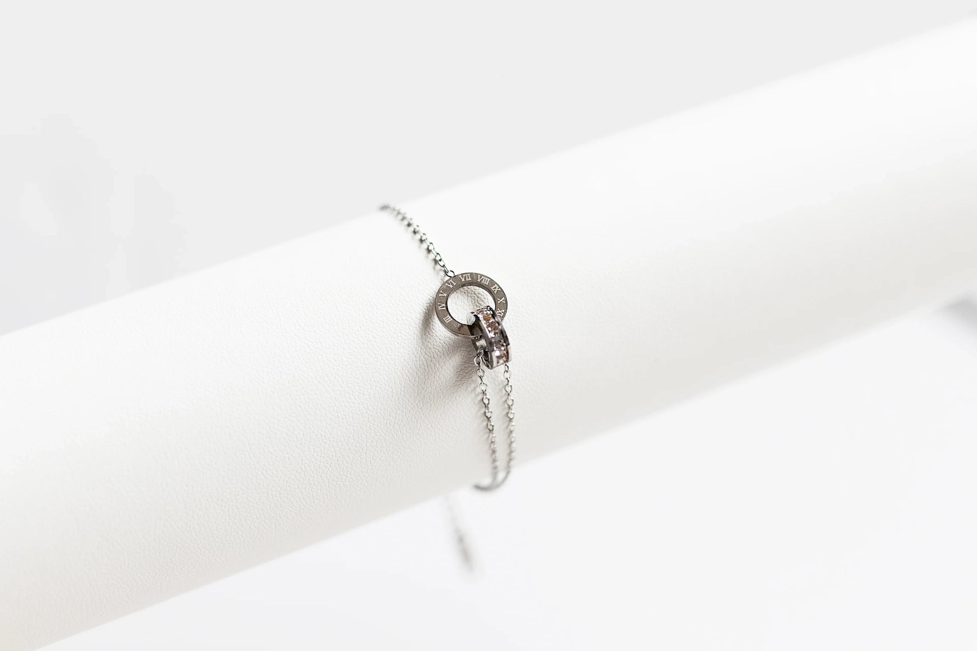 Brazalete de bisutería fina MYKOANI de acero, diseño círculo romano, fondo blanco elegante